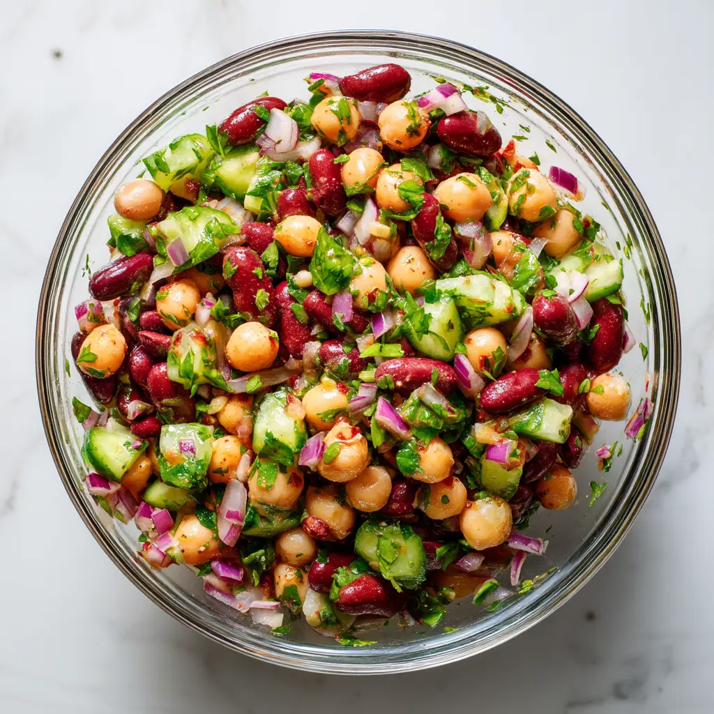 An overhead view of the High-Protein Bean Salad, showcasing all the fresh ingredients like beans, corn, and red onion before being tossed.