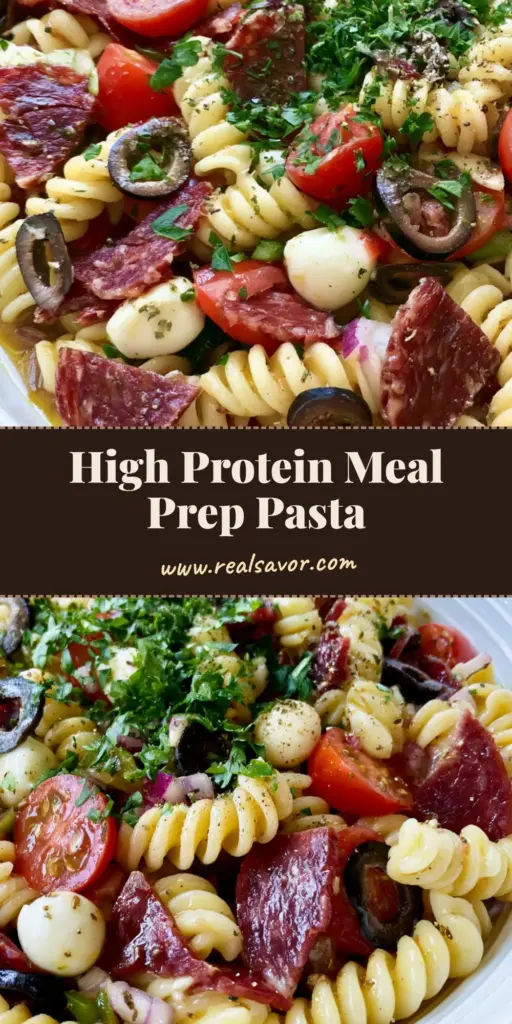 A top-down view of a High Protein Italian Pasta Salad in a white bowl, showing quartered salami, mozzarella pearls, and herbs on a wooden table.