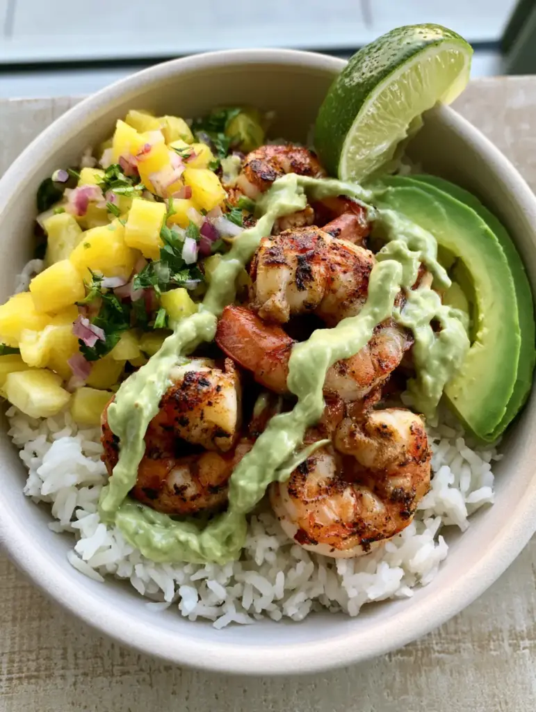 Close up of the pineapple salsa and avocado crema drizzle on a Shrimp Pineapple Rice Bowl.