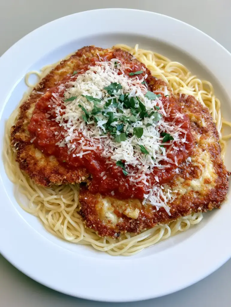 Close-up of the crispy Romano and breadcrumb crust on a Chicken Romano Recipe cutlet.